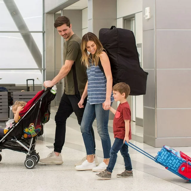 a family carrying a car seat in the backpack car seat bag