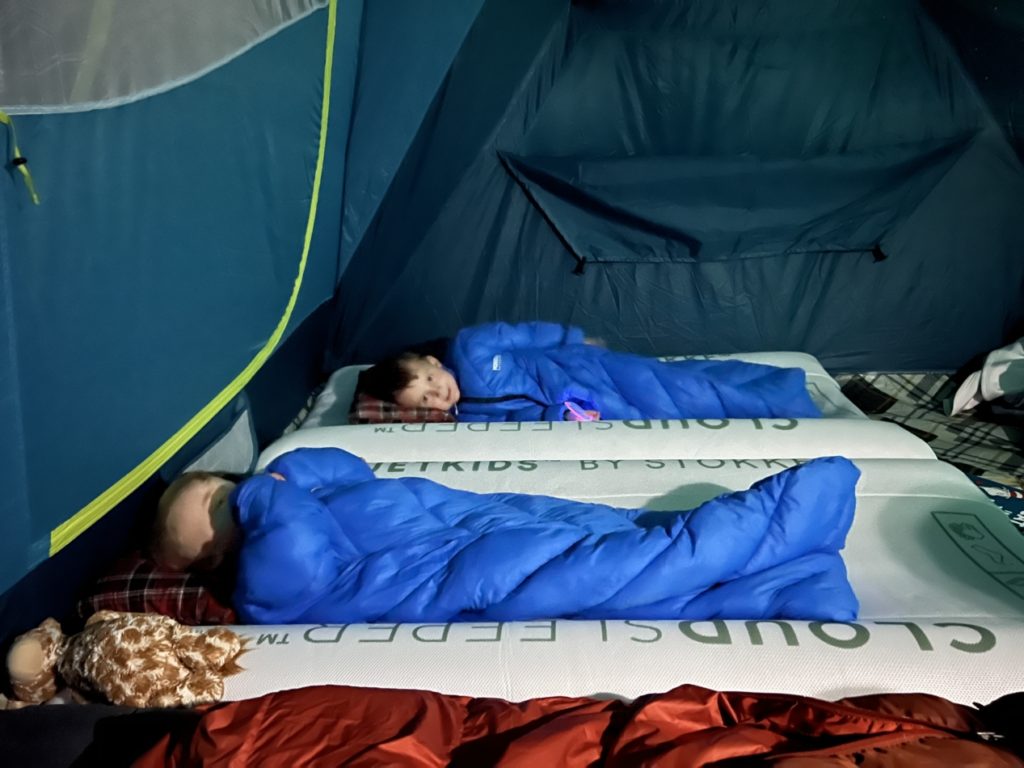 baby and toddler camping in a tent